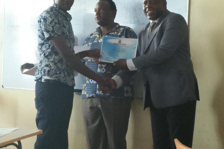 A participant being awarded a certificate after successful completion of the SPSS course